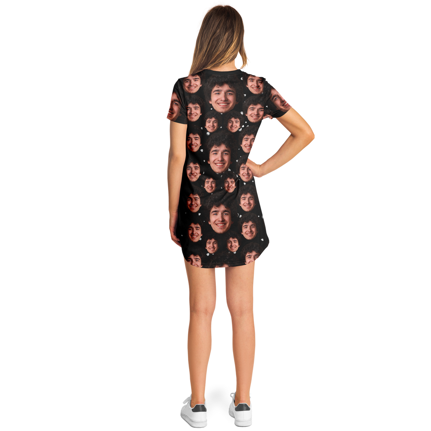 Side pose of woman in custom face print t-shirt dress with black backdrop and face pattern