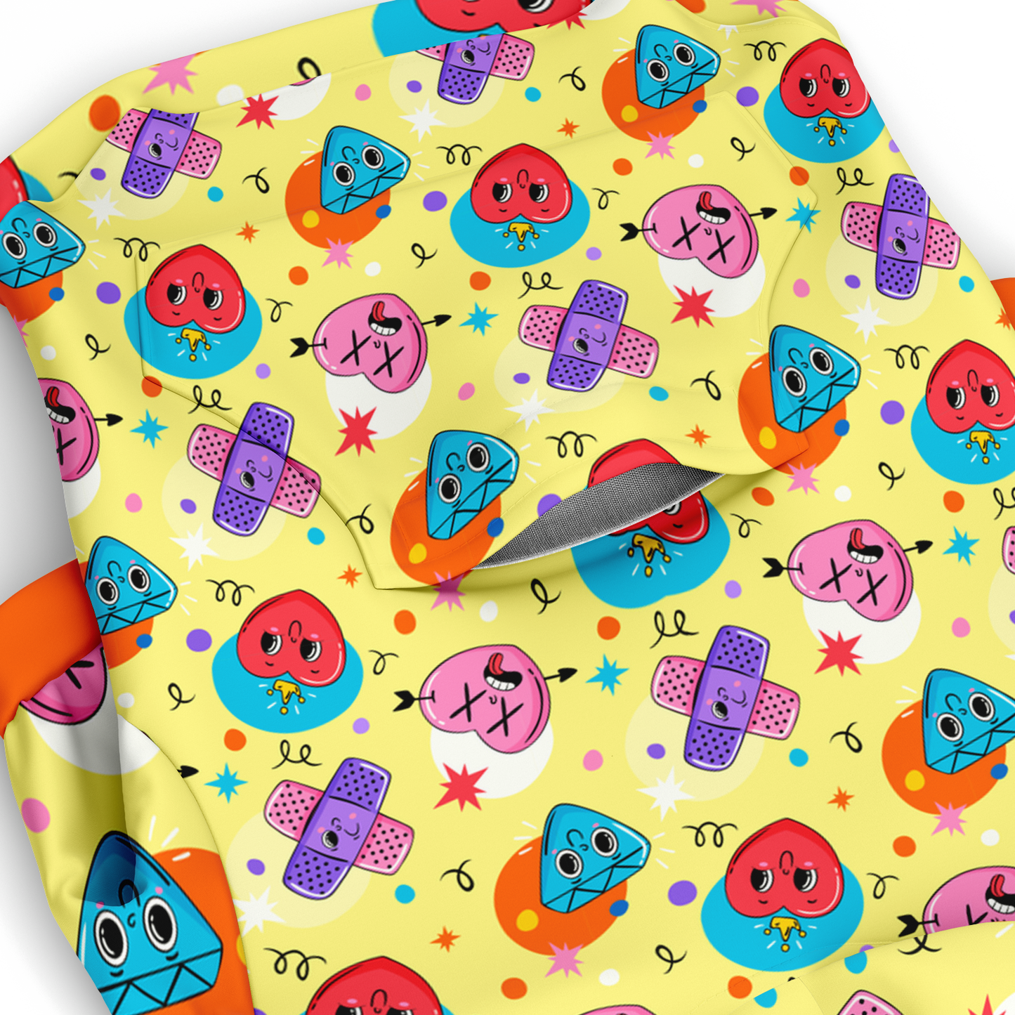 Close-up of emoji pattern on dog hoodie with smiling and winking faces