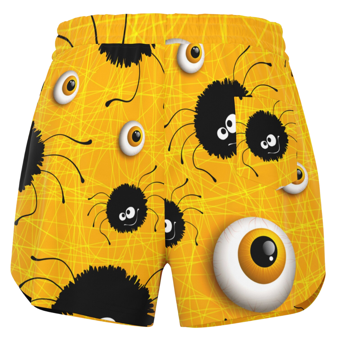 Back view of the yellow Halloween shorts laid flat, showing the elastic waistband and full pattern.