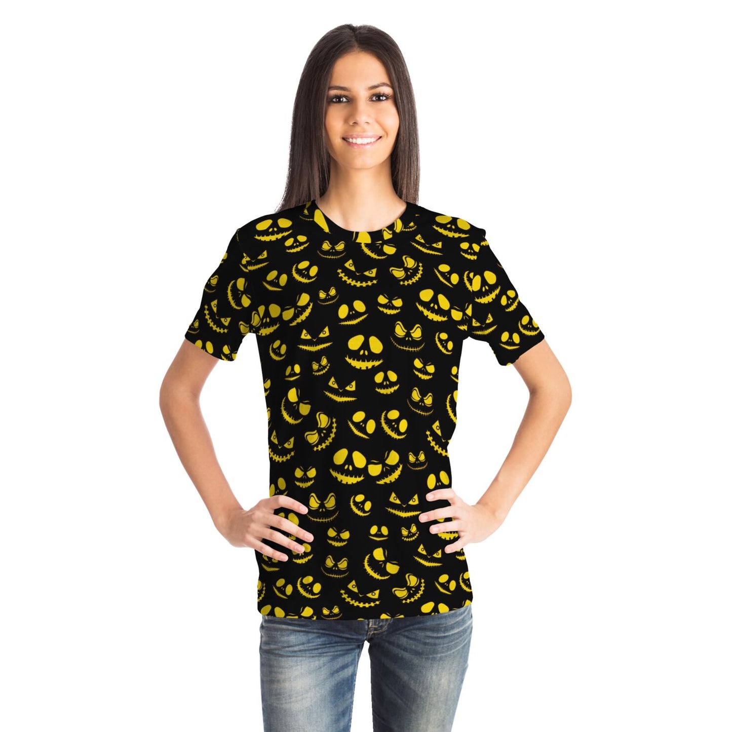 A smiling woman with her hands on her hips, wearing the black and yellow sinister grins Halloween t-shirt.