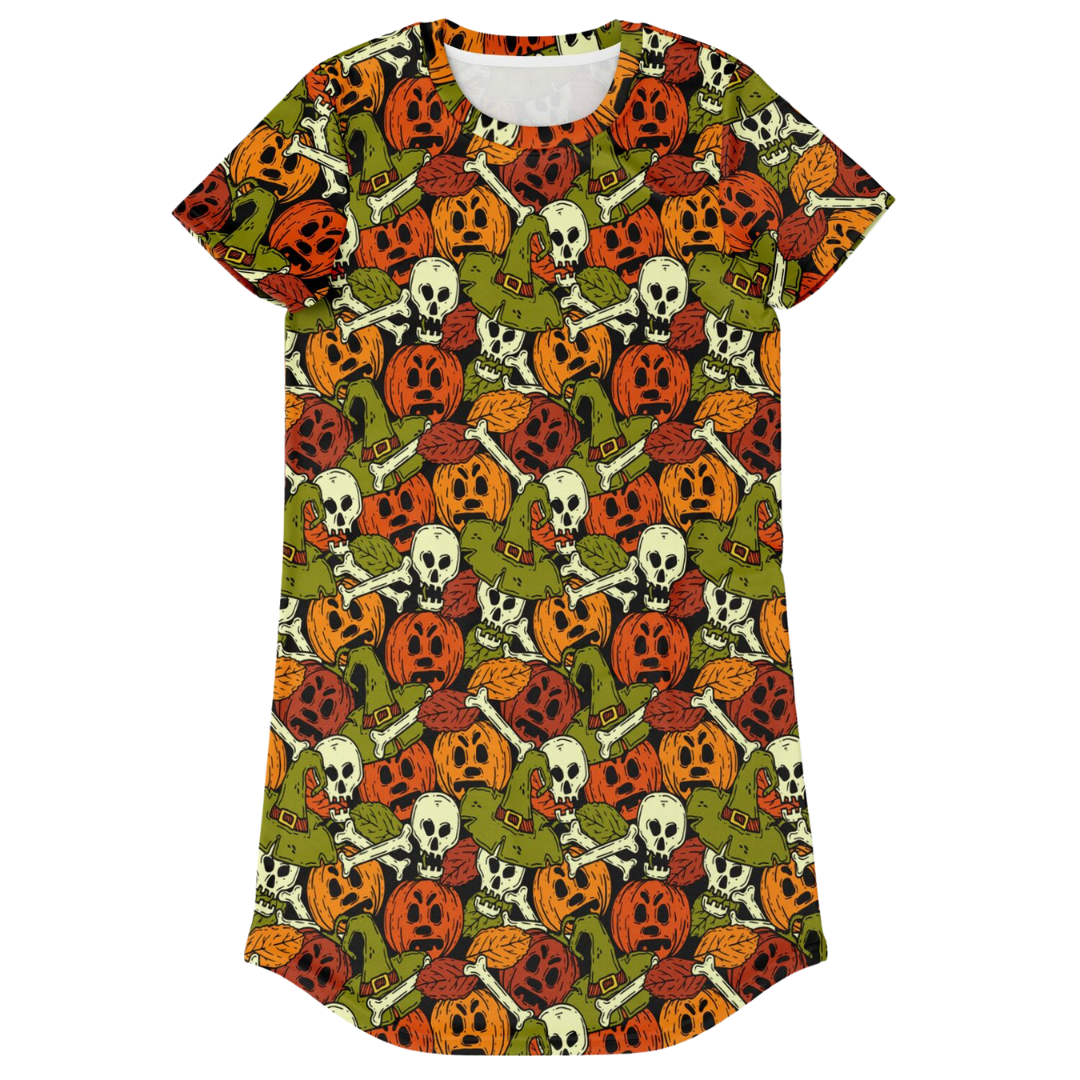 Front view of a t-shirt dress laid flat, covered in a repeating Halloween pattern of skulls and pumpkins.