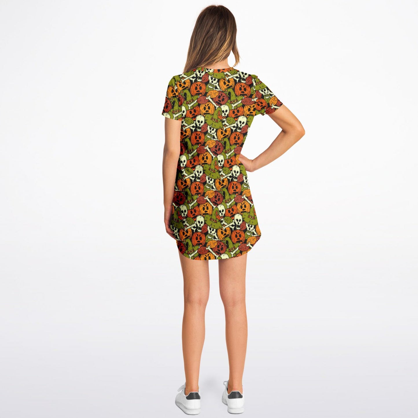 Back view of a woman with her hand on her hip, wearing the Halloween skulls and pumpkins t-shirt dress.