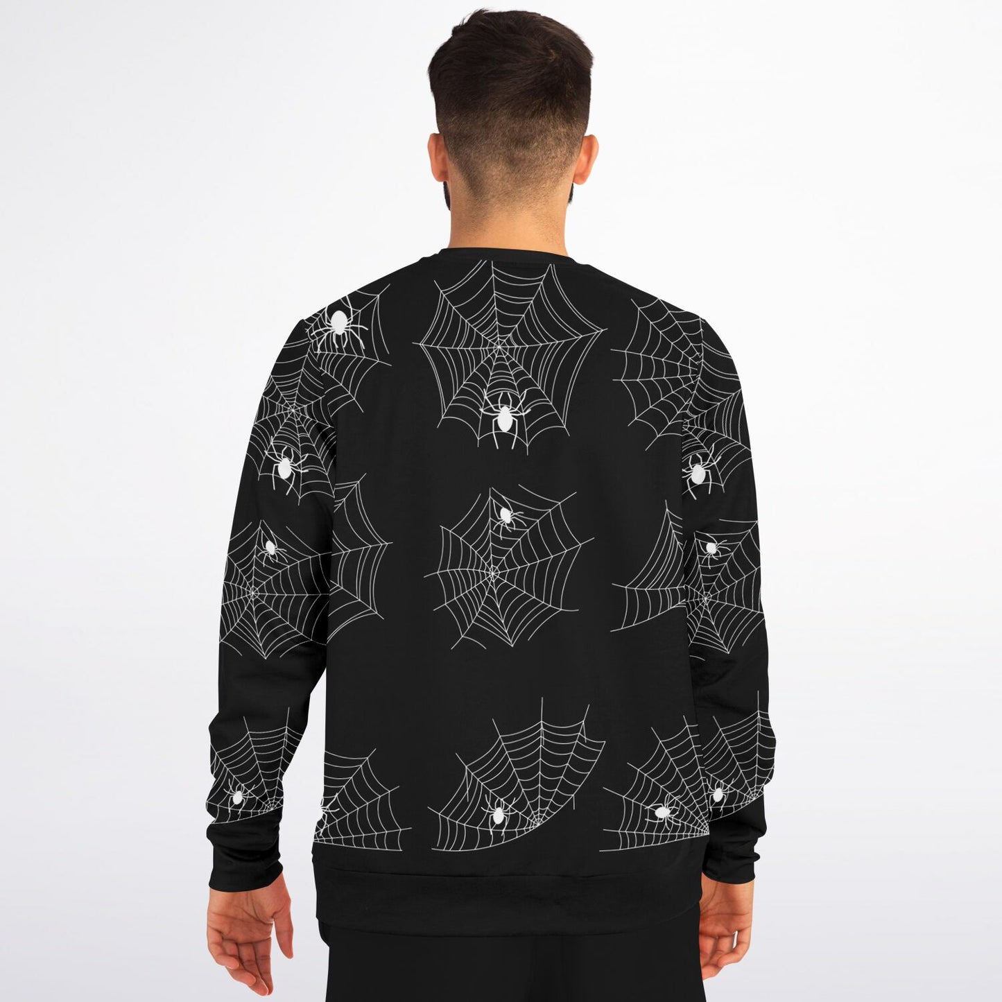Back view of a man wearing the black sweatshirt with the repeating spiderweb pattern.