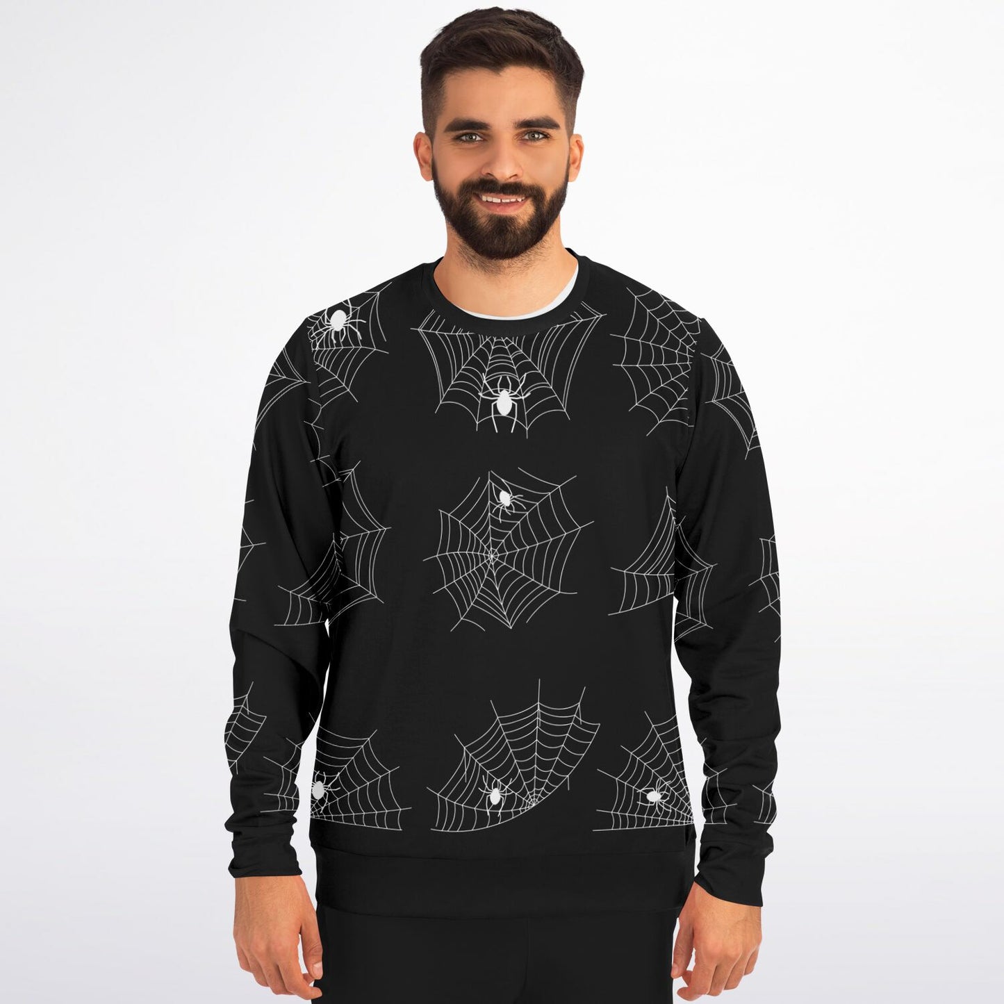 A smiling man with a beard wearing the black spiderweb pattern sweatshirt.