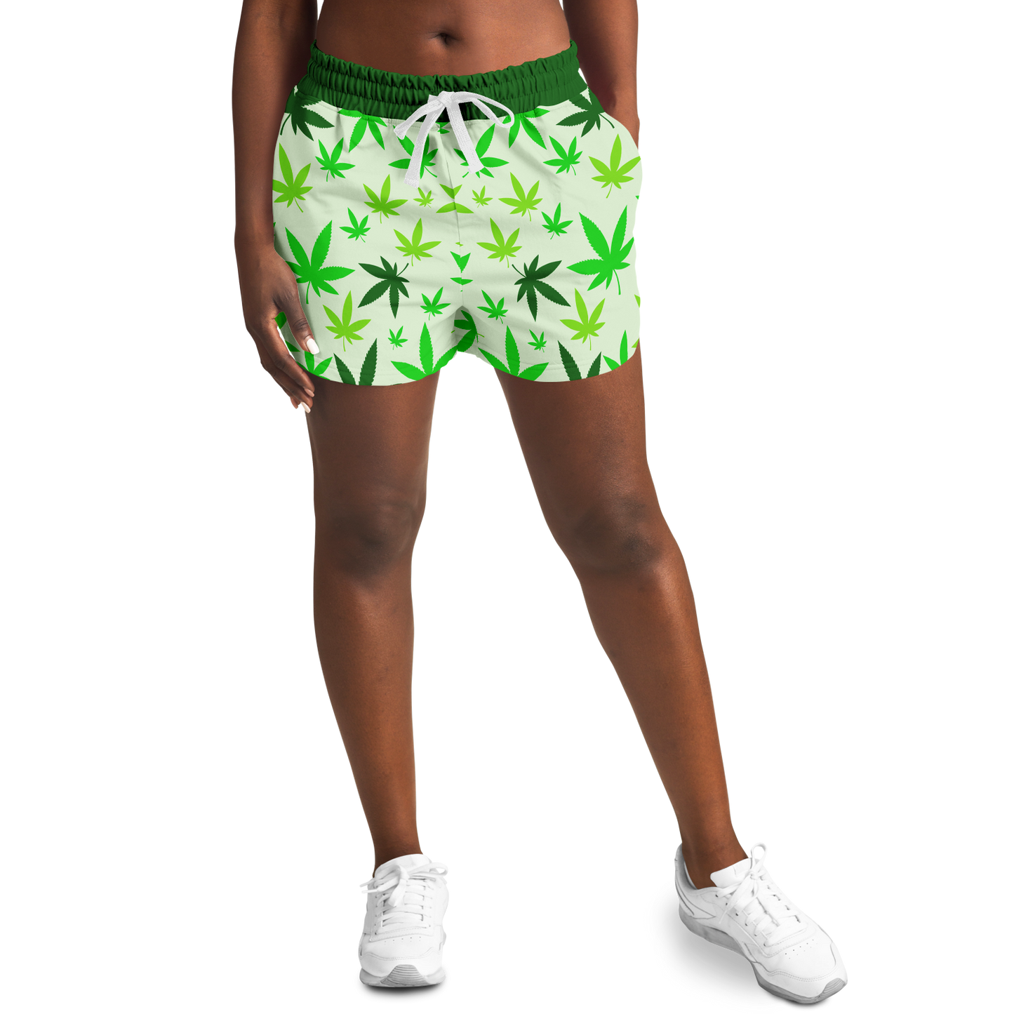 Female model front view wearing High Vibe Shorts with green cannabis leaf pattern