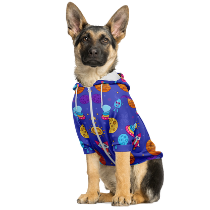 Dog sitting in Cosmo Charm dog hoodie with colorful cosmic design