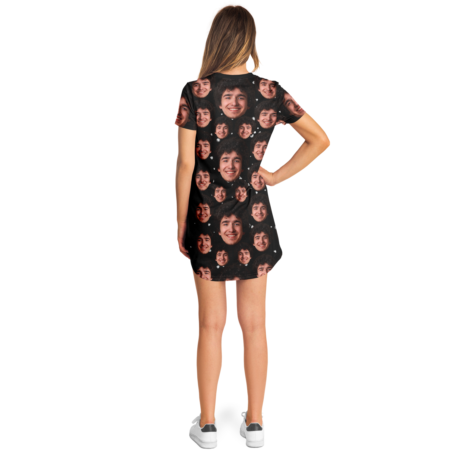 Side pose of woman in custom face print t-shirt dress with black backdrop and face pattern