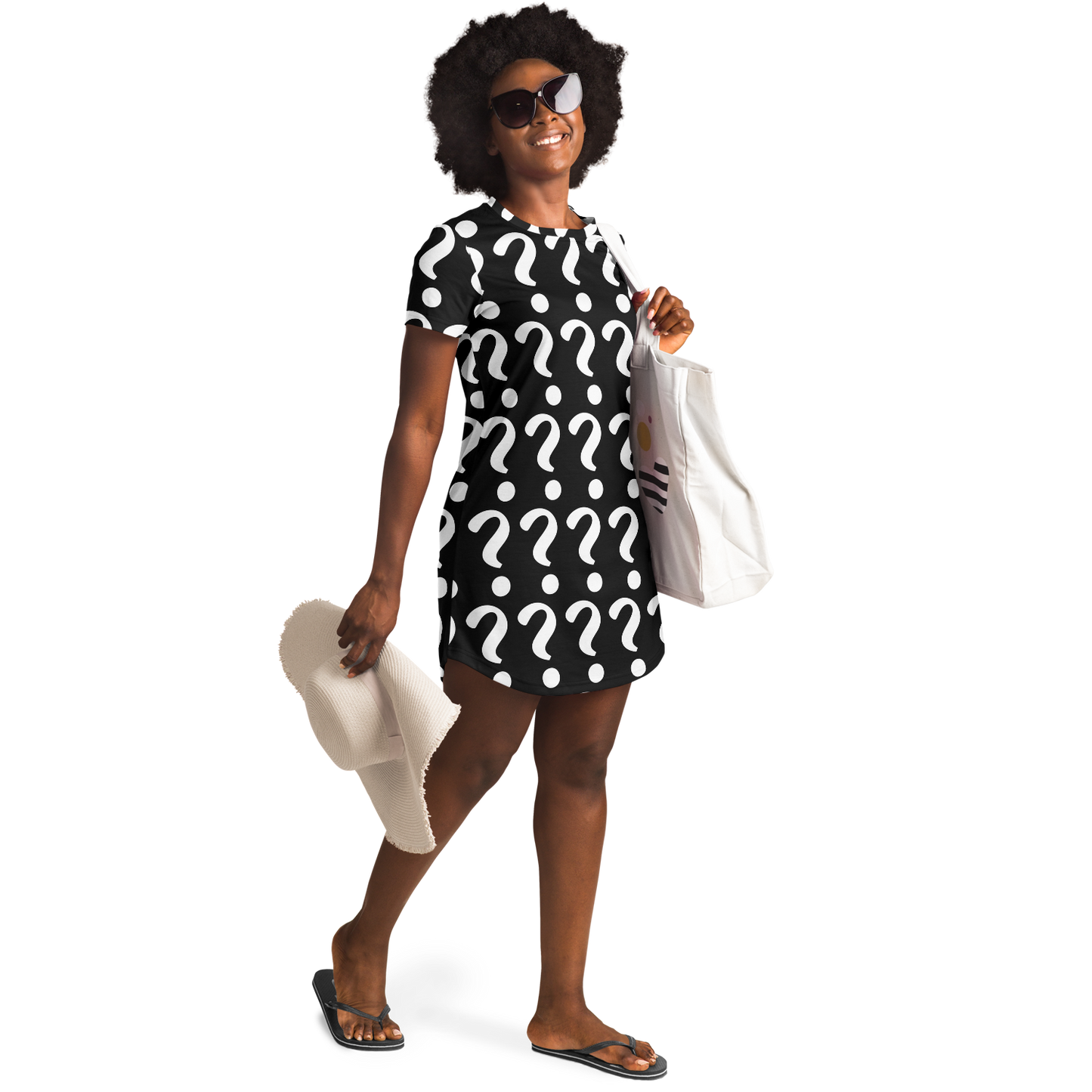 Confident woman in sunglasses wearing a custom T-shirt dress with placeholder print, holding beach accessories in a relaxed lifestyle pose
