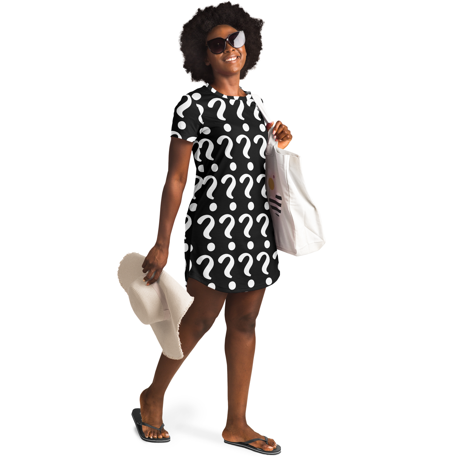 Confident woman in sunglasses wearing a custom T-shirt dress with placeholder print, holding beach accessories in a relaxed lifestyle pose