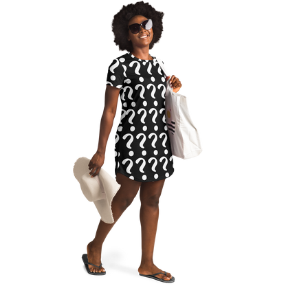 Confident woman in sunglasses wearing a custom T-shirt dress with placeholder print, holding beach accessories in a relaxed lifestyle pose