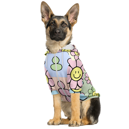 Dog sitting in floral print hoodie with pink and yellow smiley flowers