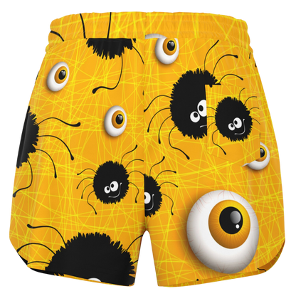 Back view of the yellow Halloween shorts laid flat, showing the elastic waistband and full pattern.