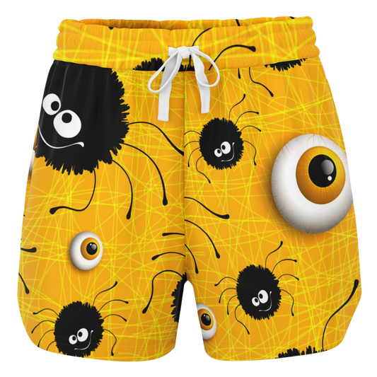 Front view of yellow shorts laid flat, showing a pattern of cartoon spiders and eyeballs with a white drawstring.