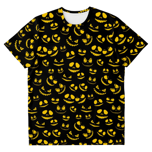 Front view of a black t-shirt laid flat, covered in a pattern of glowing yellow sinister pumpkin faces.