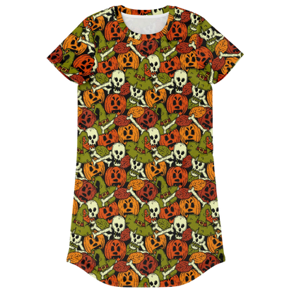 Front view of a t-shirt dress laid flat, covered in a repeating Halloween pattern of skulls and pumpkins.
