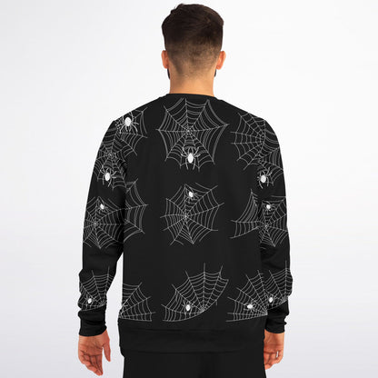 Back view of a man wearing the black sweatshirt with the repeating spiderweb pattern.