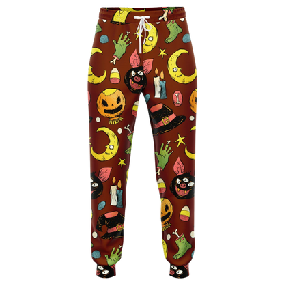 Front view of the Halloween-themed joggers laid flat, showing the repeating pattern of pumpkins and moons.