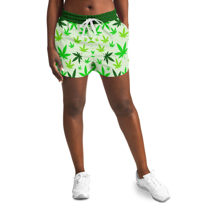  Female model front view wearing High Vibe Shorts with green cannabis leaf pattern