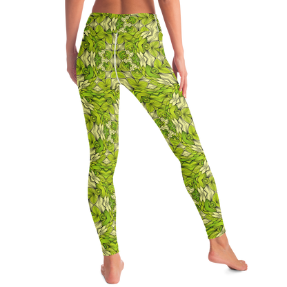 Back angled view of green leaf print leggings featuring artistic botanical design