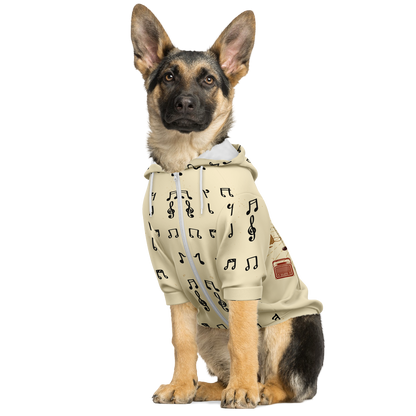 Dog sitting in Melody Beige hoodie with music notes on light beige background