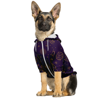 Dog sitting in purple stellar hoodie with white space-themed illustrations
